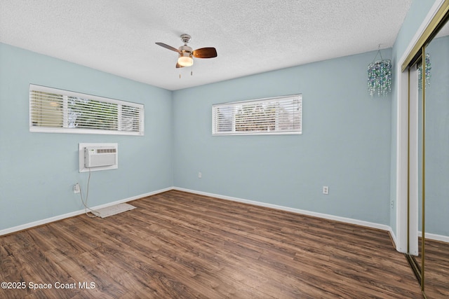 3820 Ocean Beach Blvd Unit 1, Cocoa Beach, FL 32931 - unfurnished bedroom featuring multiple windows, a closet, wood finished floors, baseboards, and a textured ceiling