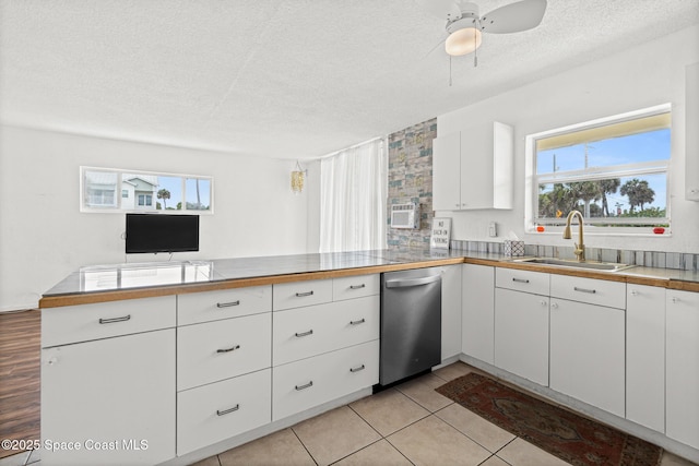 3820 Ocean Beach Blvd Unit 1, Cocoa Beach, FL 32931 - kitchen featuring dishwasher, a sink, a peninsula, a textured ceiling, and plenty of natural light