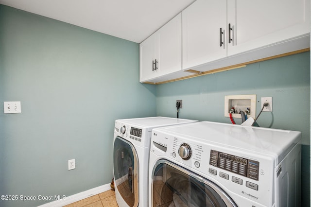 5256 Mansford Pl, Melbourne, FL 32940 - washroom with cabinet space, baseboards, separate washer and dryer, and light tile patterned floors