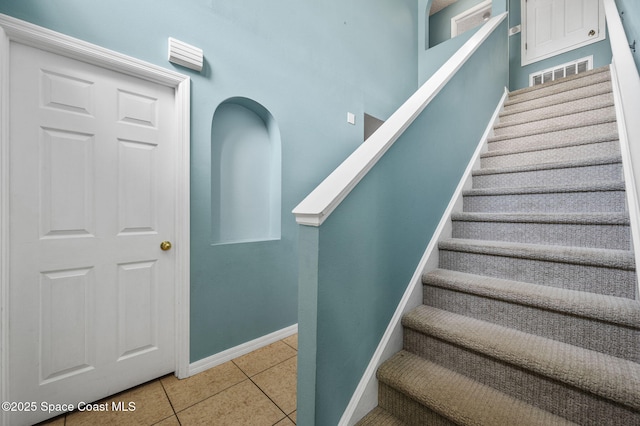 5256 Mansford Pl, Melbourne, FL 32940 - stairs featuring tile patterned floors and baseboards