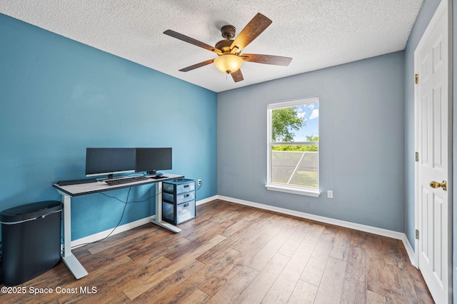 5256 Mansford Pl, Melbourne, FL 32940 - home office featuring a ceiling fan, baseboards, a textured ceiling, and wood finished floors