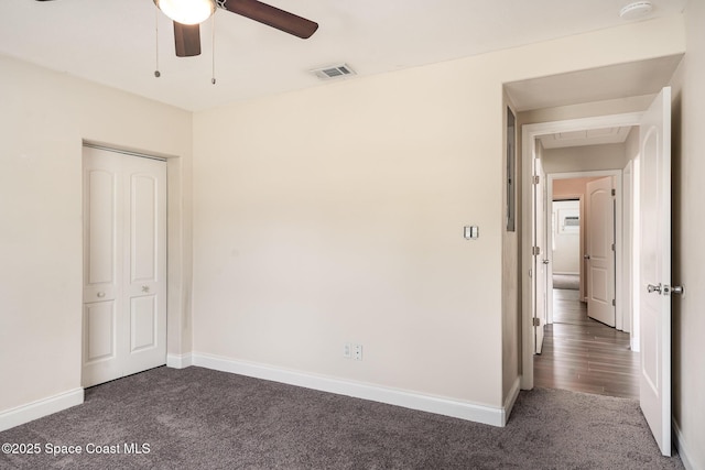 485 Poinciana Dr, Melbourne, FL 32935 - unfurnished bedroom featuring dark colored carpet, baseboards, ceiling fan, and a closet