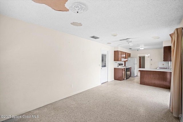 1155 Montego Bay Dr N, Merritt Island, FL 32953 - unfurnished living room with dark aggregate flooring, ceiling fan, and a textured ceiling