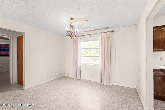1155 Montego Bay Dr N, Merritt Island, FL 32953 - unfurnished dining area with a textured ceiling, a chandelier, and dark aggregate flooring