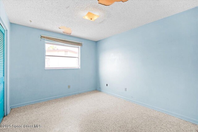 1155 Montego Bay Dr N, Merritt Island, FL 32953 - empty room featuring a textured ceiling and baseboards