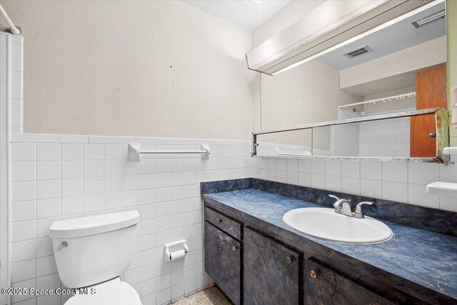 1155 Montego Bay Dr N, Merritt Island, FL 32953 - full bath with vanity, wainscoting, a tile shower, and tile walls