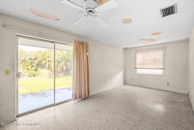 1155 Montego Bay Dr N, Merritt Island, FL 32953 - spare room featuring speckle patterned floor, a textured ceiling, and a ceiling fan
