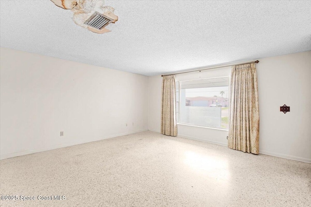 1155 Montego Bay Dr N, Merritt Island, FL 32953 - spare room with speckled floor and a textured ceiling