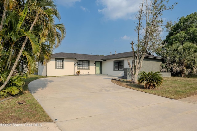 629 Tupelo Dr, Melbourne, FL 32935 - view of front of property with stucco siding and concrete driveway