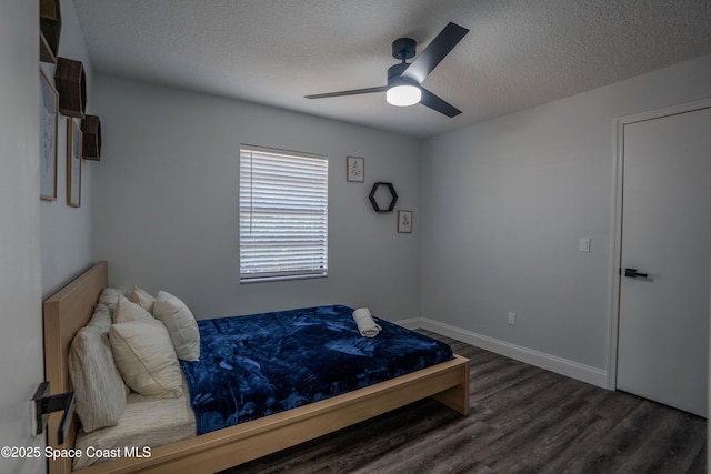 629 Tupelo Dr, Melbourne, FL 32935 - bedroom with a textured ceiling, wood finished floors, and a ceiling fan