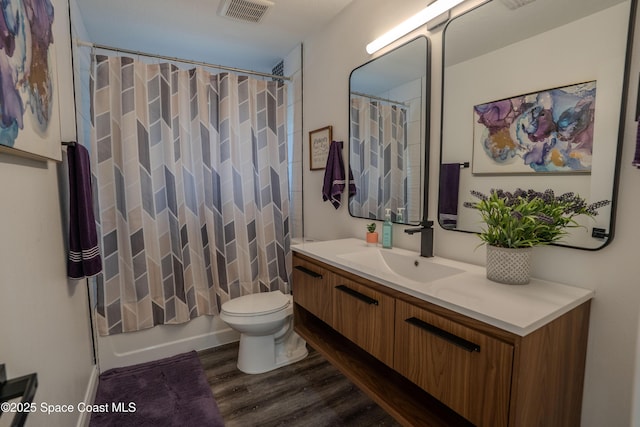 629 Tupelo Dr, Melbourne, FL 32935 - bathroom featuring wood finished floors, vanity, and toilet