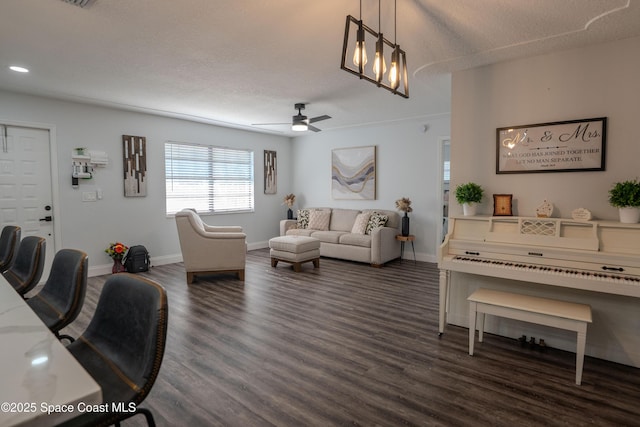 629 Tupelo Dr, Melbourne, FL 32935 - living area with dark wood finished floors, ceiling fan, baseboards, a textured ceiling, and recessed lighting