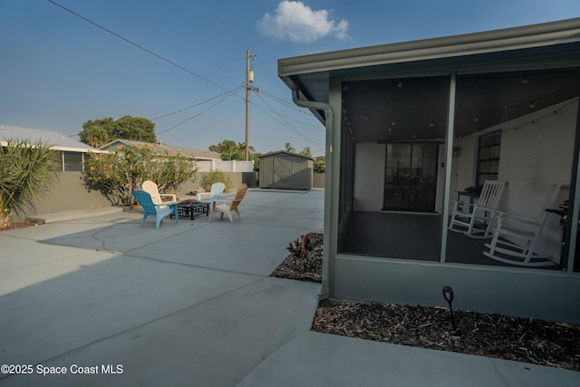 629 Tupelo Dr, Melbourne, FL 32935 - fenced backyard featuring a patio area, a fire pit, and a sunroom
