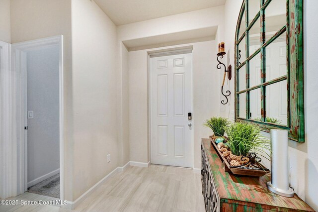 2365 Roygaris St NW, Palm Bay, FL 32907 - doorway to outside with baseboards and light wood-style flooring