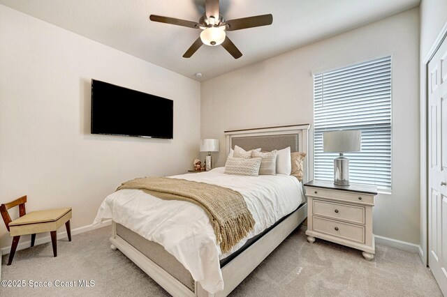2365 Roygaris St NW, Palm Bay, FL 32907 - bedroom with light colored carpet, a closet, baseboards, and ceiling fan