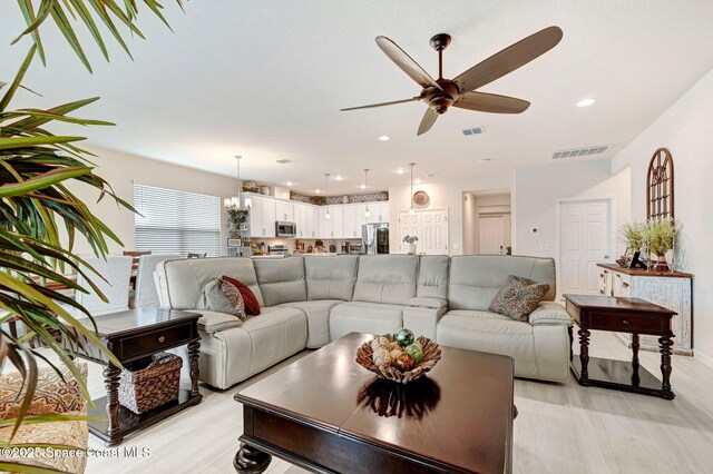 2365 Roygaris St NW, Palm Bay, FL 32907 - living room with ceiling fan, recessed lighting, and a chandelier