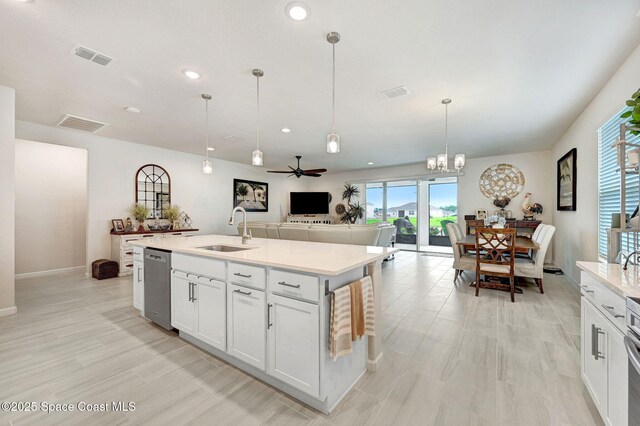 2365 Roygaris St NW, Palm Bay, FL 32907 - kitchen with a sink, stainless steel dishwasher, light countertops, open floor plan, and recessed lighting