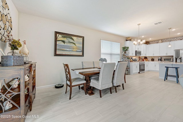 2365 Roygaris St NW, Palm Bay, FL 32907 - dining space with a chandelier, recessed lighting, and baseboards