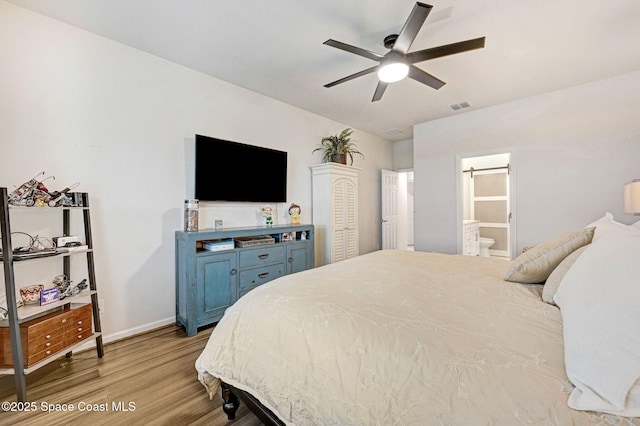 2365 Roygaris St NW, Palm Bay, FL 32907 - bedroom featuring light wood-style floors, baseboards, and ensuite bath
