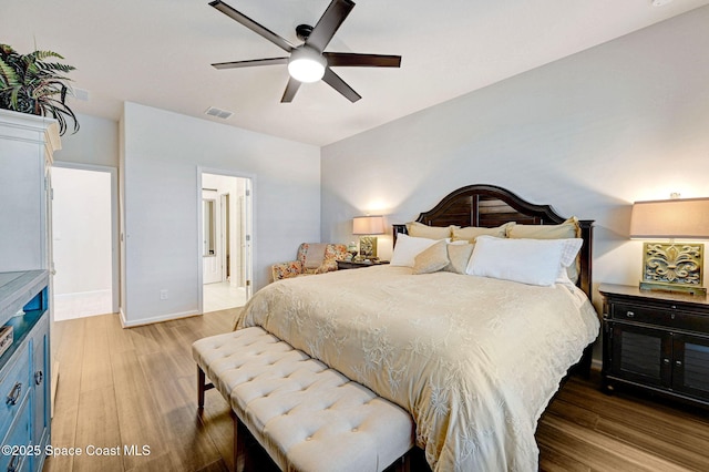 2365 Roygaris St NW, Palm Bay, FL 32907 - bedroom with wood finished floors, baseboards, ceiling fan, and connected bathroom