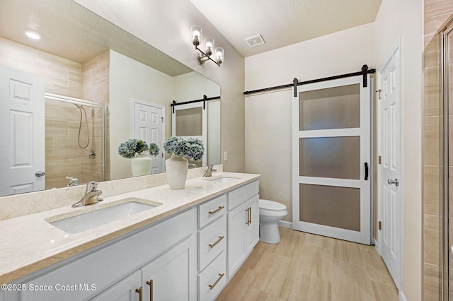2365 Roygaris St NW, Palm Bay, FL 32907 - bathroom featuring double vanity, a shower stall, and toilet