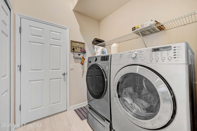 2365 Roygaris St NW, Palm Bay, FL 32907 - laundry room with washing machine and clothes dryer and baseboards