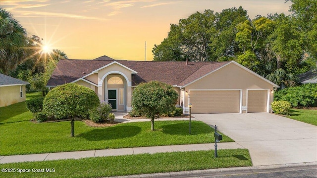 1090 Spring Oak Dr, Melbourne, FL 32901 - single story home with a garage, stucco siding, a lawn, concrete driveway, and roof with shingles