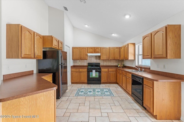 1090 Spring Oak Dr, Melbourne, FL 32901 - kitchen featuring black appliances, under cabinet range hood, decorative backsplash, brown cabinets, and high vaulted ceiling