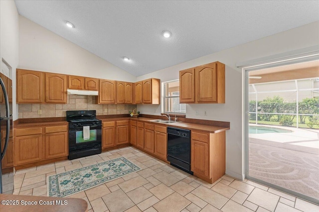 1090 Spring Oak Dr, Melbourne, FL 32901 - kitchen featuring black appliances, under cabinet range hood, lofted ceiling, backsplash, and brown cabinetry