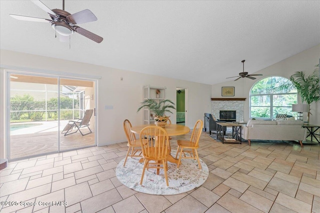 1090 Spring Oak Dr, Melbourne, FL 32901 - dining room featuring a ceiling fan, a glass covered fireplace, vaulted ceiling, and a sunroom