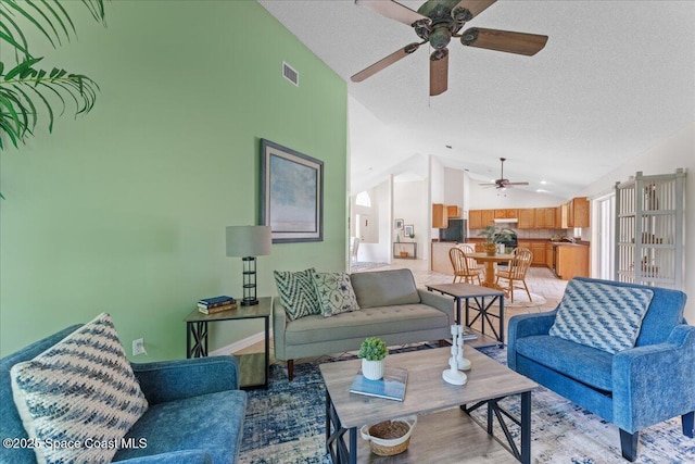 1090 Spring Oak Dr, Melbourne, FL 32901 - living room with ceiling fan, lofted ceiling, light wood-style flooring, and a textured ceiling
