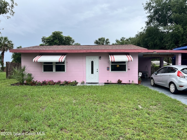155 Carolina Ave, Melbourne, FL 32935 - ranch-style house with a carport, a front yard, and a shingled roof