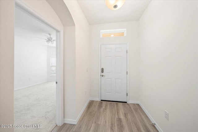 8342 Laguna Cir, Micco, FL 32976 - entryway featuring light wood-style flooring, baseboards, and arched walkways