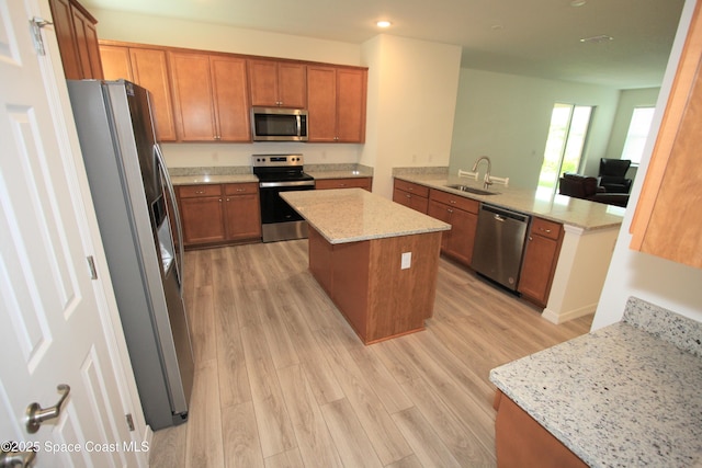 8342 Laguna Cir, Micco, FL 32976 - kitchen featuring appliances with stainless steel finishes, a sink, light wood-type flooring, brown cabinets, and recessed lighting