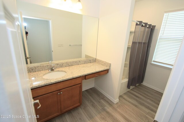 8342 Laguna Cir, Micco, FL 32976 - full bath featuring wood finished floors, vanity, baseboards, and shower / bathtub combination with curtain