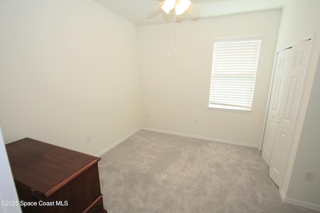 8342 Laguna Cir, Micco, FL 32976 - unfurnished bedroom featuring light colored carpet, baseboards, and a ceiling fan