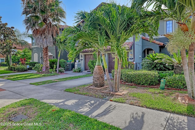 681 Ventura Dr, Satellite Beach, FL 32937 - view of front of property featuring stucco siding, concrete driveway, and an attached garage