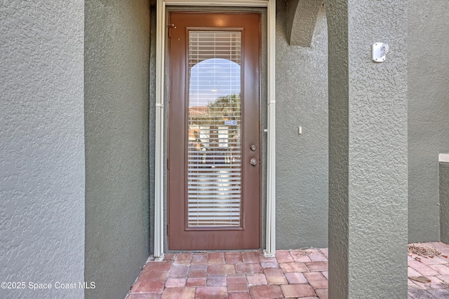 681 Ventura Dr, Satellite Beach, FL 32937 - doorway to property featuring stucco siding