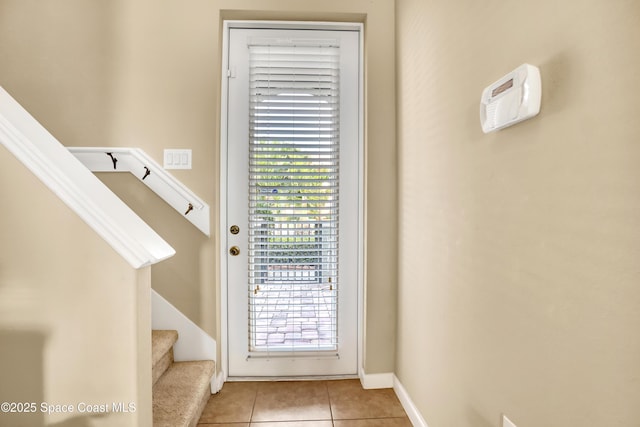 681 Ventura Dr, Satellite Beach, FL 32937 - entryway with light tile patterned floors, stairs, and baseboards