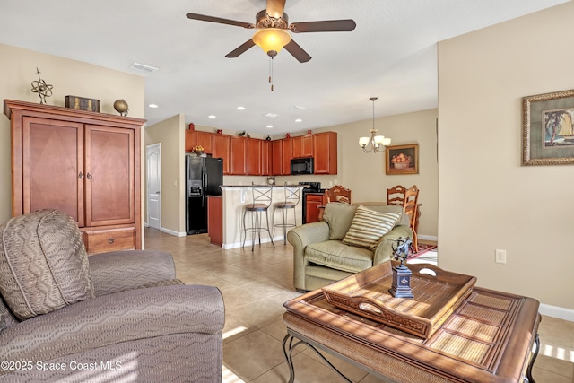 681 Ventura Dr, Satellite Beach, FL 32937 - living room with ceiling fan, a chandelier, light tile patterned floors, baseboards, and recessed lighting