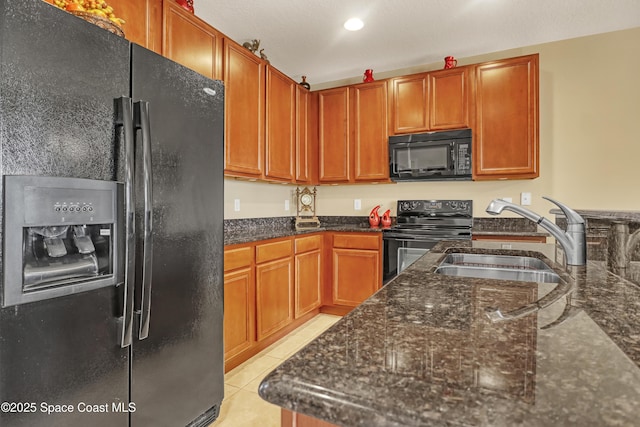 681 Ventura Dr, Satellite Beach, FL 32937 - kitchen featuring black appliances, a sink, dark stone counters, light tile patterned floors, and recessed lighting