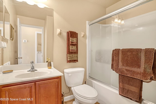681 Ventura Dr, Satellite Beach, FL 32937 - full bathroom featuring vanity, shower / bath combination with glass door, toilet, and washer / clothes dryer