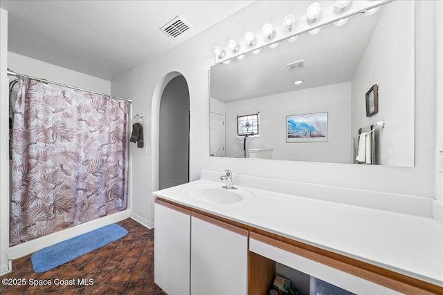 1250 Corning Ave NW, Palm Bay, FL 32907 - full bathroom with vanity, curtained shower, and toilet
