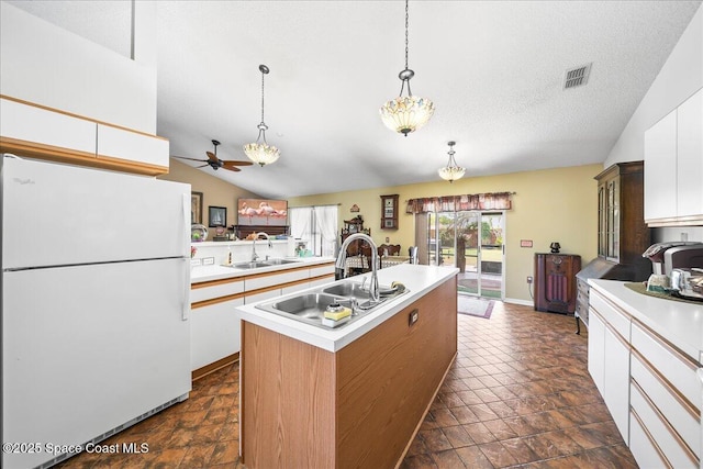 1250 Corning Ave NW, Palm Bay, FL 32907 - kitchen with freestanding refrigerator, a sink, vaulted ceiling, ceiling fan, and light countertops