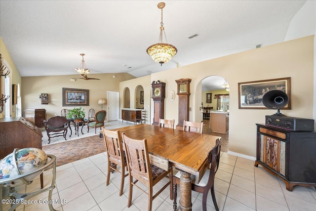 1250 Corning Ave NW, Palm Bay, FL 32907 - dining space featuring arched walkways, lofted ceiling, light tile patterned floors, and a chandelier