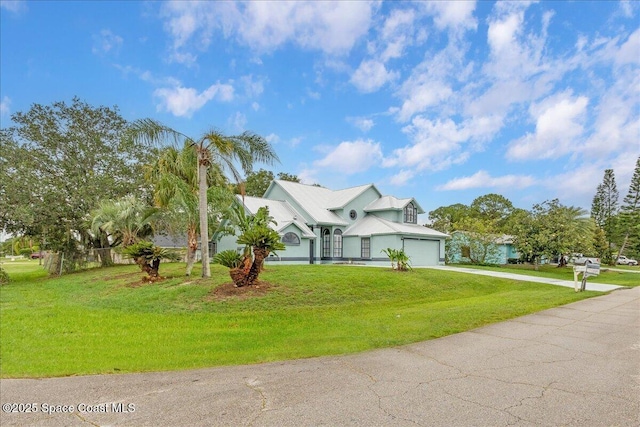 817 Seven Gables Cir SE, Palm Bay, FL 32909 - view of front of property featuring concrete driveway, a front lawn, a garage, and metal roof
