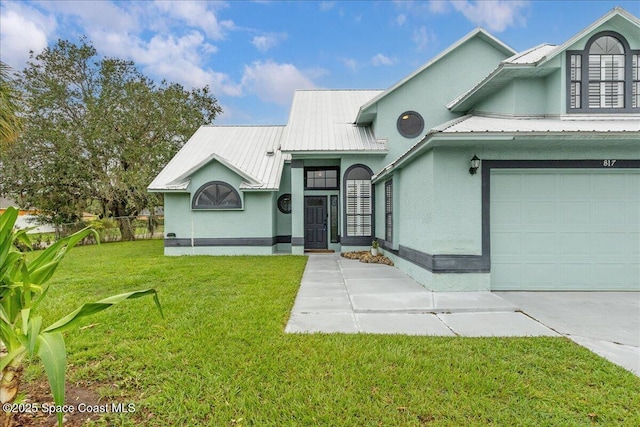 817 Seven Gables Cir SE, Palm Bay, FL 32909 - view of front of house with metal roof, a front yard, and stucco siding