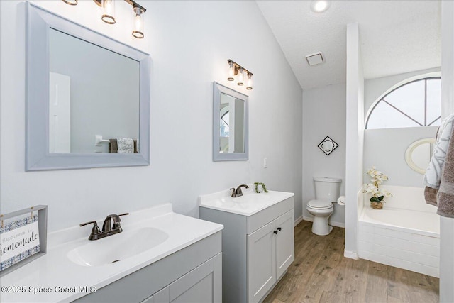 817 Seven Gables Cir SE, Palm Bay, FL 32909 - full bathroom featuring a bath, wood finished floors, toilet, and two vanities