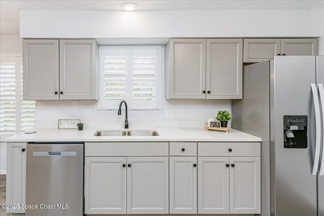 817 Seven Gables Cir SE, Palm Bay, FL 32909 - kitchen featuring appliances with stainless steel finishes, a sink, light countertops, and gray cabinets