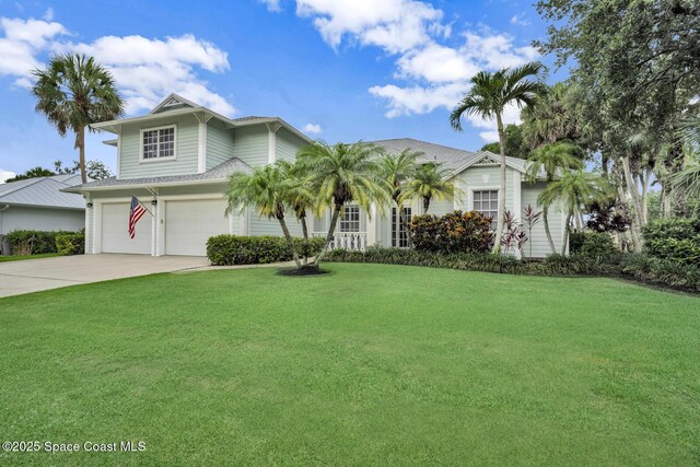 105 38th Ct, Vero Beach, FL 32968 - view of front facade with a garage, a front lawn, and concrete driveway